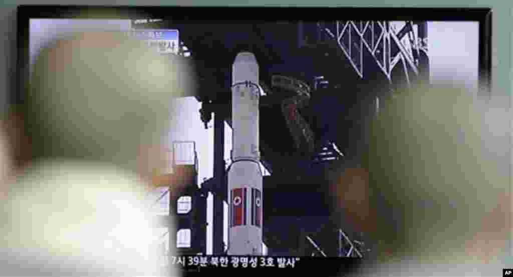 South Korean Buddhist monks watch a tv news reporting about North Korea's long-range rocket at Seoul train station in Seoul, South Korea, Friday, April 13, 2012. North Korea fired a long-range rocket early Friday, South Korean and U.S. officials said, de