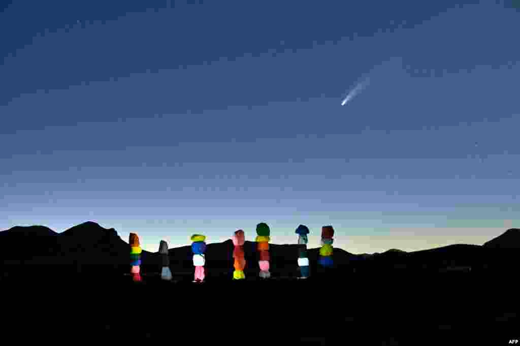 Comet NEOWISE or C/2020 F3 is seen in the sky, above the &quot;Seven Magic Mountains&quot; art installation by artist Ugo Rondinone, in Jean, Nevada, July 15, 2020.