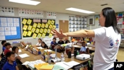 In this Sept. 30, 2016 photo, teacher Regina Yang leads a bilingual Korean-English language immersion classes at Porter Ranch Community School in Los Angeles. (AP Photo/Nick Ut)