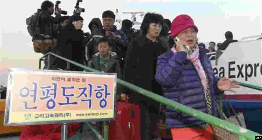 People arrive from Yeonpyeong Island, at Incheon port, west of Seoul, South Korea, Tuesday, Nov. 23, 2010. North Korea bombarded the South Korean island near their disputed western border Tuesday, setting buildings ablaze and killing at least one marine a