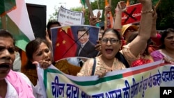 Activists shout slogans against China during a protest in New Delhi July 4, 2017. The protest was over China's decision to suspend pilgrimages to a sacred site in Tibet following tension between Indian and Chinese troops along the India-China border. 