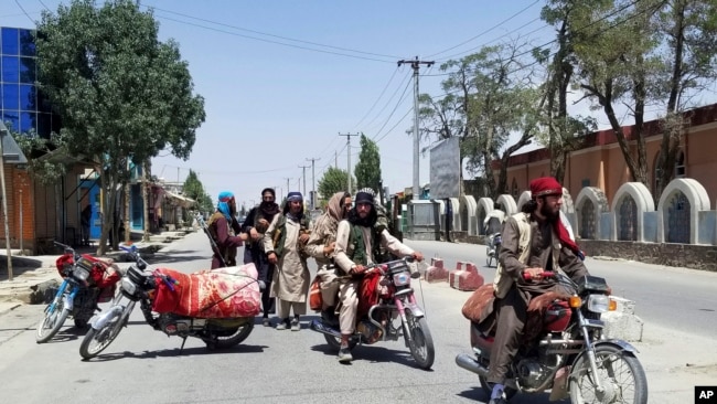 Taliban fighters patrol inside the city of Ghazni, southwest of Kabul, Afghanistan, Thursday, Aug. 12, 2021.