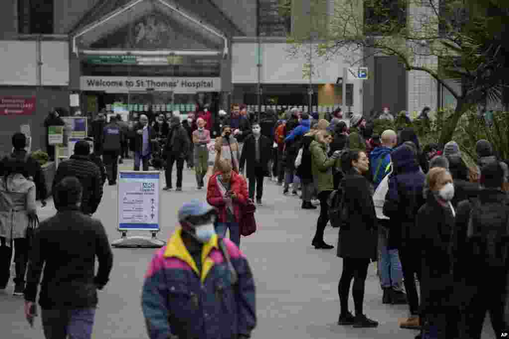 People line up for coronavirus booster jabs at St. Thomas&#39; Hospital, in London.