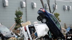Cars upended and destroyed by the tsunami that struck Miyagi Prefecture following Friday's 8.9 magnitude earthquake in Sendai, Japan, March 14, 2011.