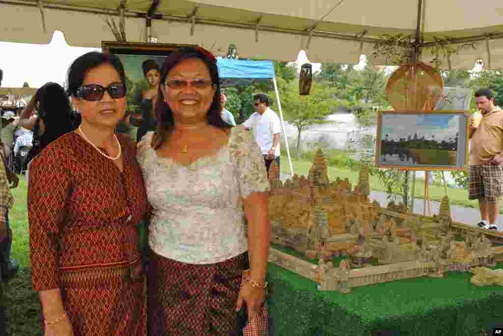 The lead organizers, Sophia Tep (left) and Somony Yann (right), proudly stand next to a five-thousand-dollar replica of Angkor Wat, which the Cambodian Community Day group commissioned from Cambodia.