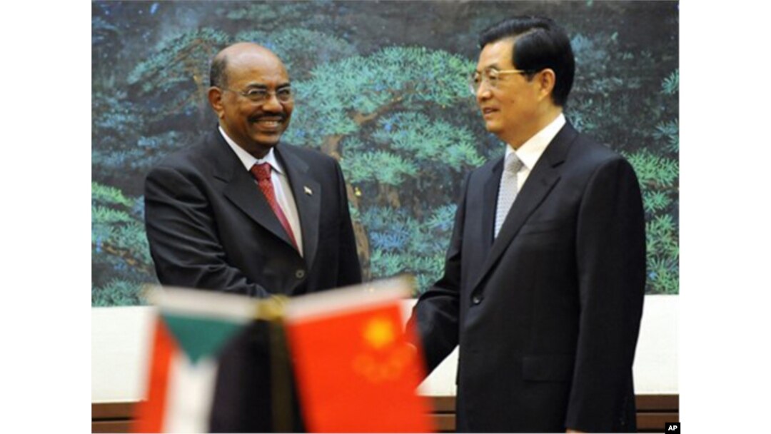 FILE - Chinese President Hu Jintao, right, shakes hands with Sudan's President Omar al-Bashir during the signing ceremony at the Great Hall of the People in Beijing, China, June 29, 2011