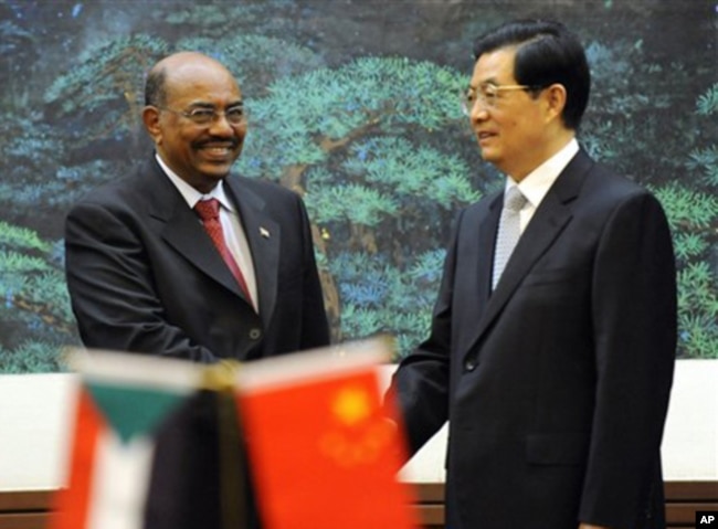 FILE - Chinese President Hu Jintao, right, shakes hands with Sudan's President Omar al-Bashir during the signing ceremony at the Great Hall of the People in Beijing, China, June 29, 2011