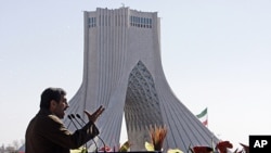Iranian President Mahmoud Ahmadinejad gestures as he deliver his speech near the Azadi (freedom) tower at a rally to mark the 33rd anniversary of the Islamic Revolution that toppled the country's pro-Western monarchy and brought Islamic clerics to power, 