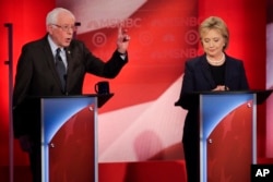 Democratic presidential candidate Senator Bernie Sanders makes a point as rival candidate Hillary Clinton listens during a presidential primary debate hosted by MSNBC in Durham, N.H., Feb. 4, 2016.