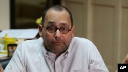 FILE - Jose Luis Martin "Chito" Gascon, chair of the Commission on Human Rights (CHR) gestures during an interview in Quezon City, north of Manila, Philippines, Sept. 9, 2016.