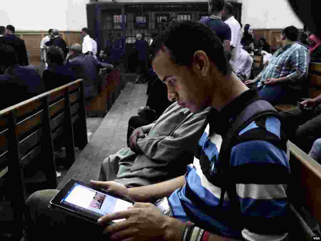 Political activist and law student Tarek Mohamed Hussain, Also known as &lsquo;Tito&rsquo;, he tweets while he is waiting for his brother&rsquo; trial in September of 2014. His brother, Mahmoud Mohamed, then 17, was arrested after wearing a tee-shirt that said, &ldquo;Homeland without Torture!&rdquo; in Arabic about 200 days before the hearing. The family accuses authorities of deliberately delaying the procedures to keep Mohamed behind bars. (H. Elrasam/VOA)