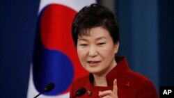 South Korean President Park Geun-hye answers to a reporter's question during her news conference at the Presidential Blue House in Seoul, South Korea, Wednesday, Jan. 13, 2016.