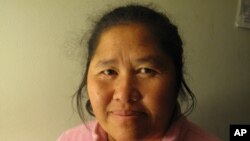 Cher Vang stays connected with the far-flung Hmong community via teleconferencing programming.