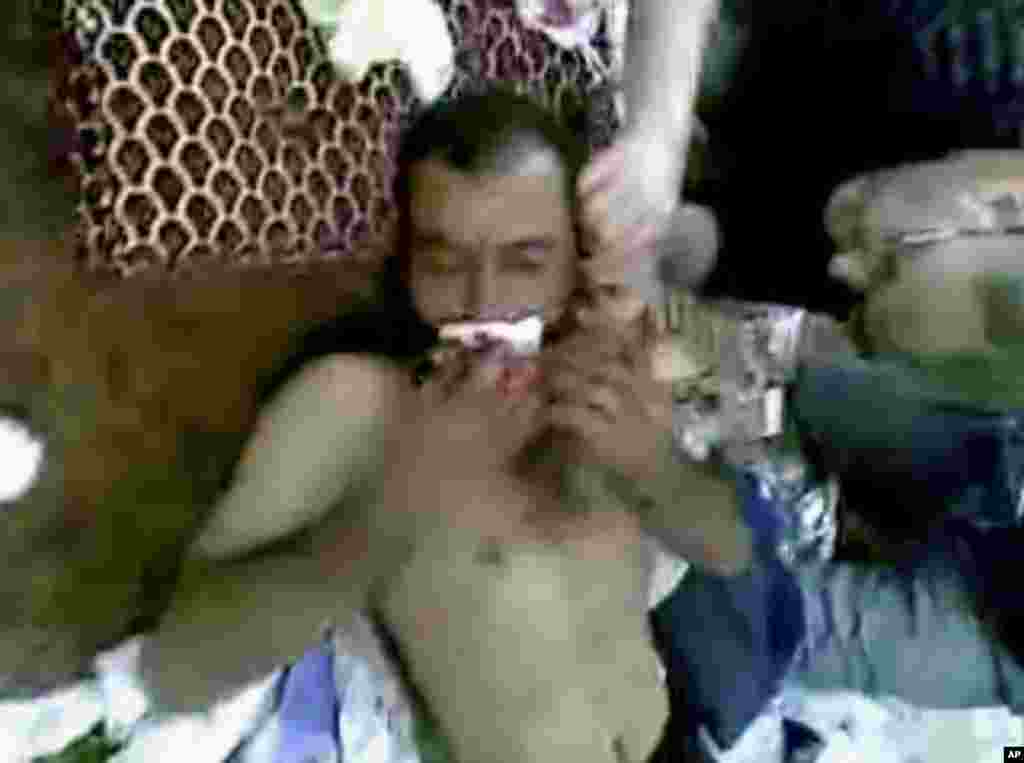 This image made from amateur video released by Shaam News Network and accessed Saturday, June 9, 2012, purports to show an injured man being treated in a mosque following the shelling in Dara'a, Syria.