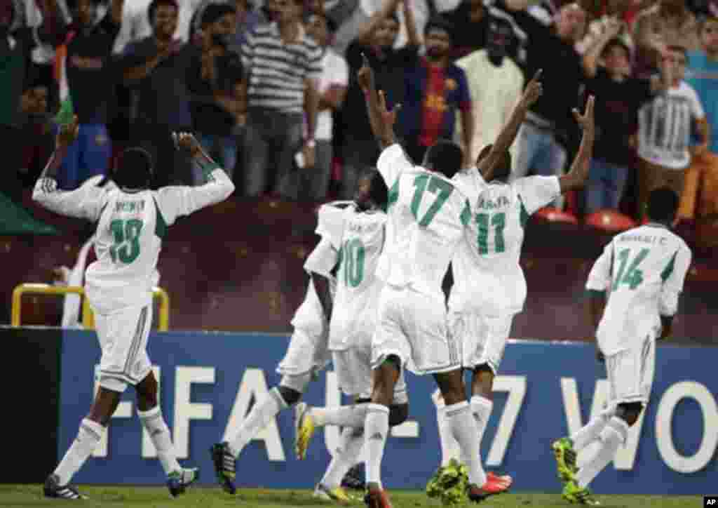 Nigeria players celebrate their teammate Musa Muhammed's goal against Mexico during the World Cup U-17 final soccer match between Nigeria and Mexico at Mohammad Bin Zayed stadium in Abu Dhabi, United Arab Emirates, Friday, Nov. 8, 2013. (AP Photo/Hassan A