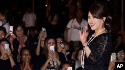 FILE - Thai Princess Ubolratana Mahidol waves outside the Grand Palace in Bangkok, Thailand, Oct. 27, 2017. 