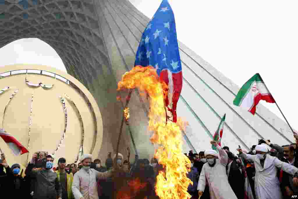 Iranian clerics burn U.S. flags during a rally marking the 43rd anniversary of the 1979 Islamic Revolution, at the Azadi (Freedom) square in Tehran.