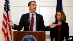 FILE - Virginia Gov. Ralph Northam, left, gestures as his wife, Pam, listens during a press conference in the Governor's Mansion at the Capitol in Richmond, Virginia, Feb. 2, 2019.