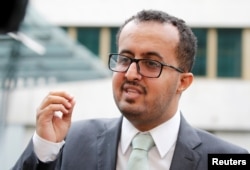Hamza al-Kamali, member of the delegation of the government of Yemen, talks to reporters outside a hotel in Geneva, Sept. 6, 2018.
