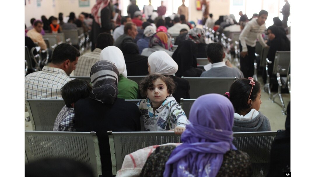FILE - Australian Foreign Minister Julie Bishop visits a Syrian refugee compound in Amman, Jordan, to meet with UNHCR representative to Jordan Andrew Harper, regarding the Syrian refugee situation, April 21, 2014.