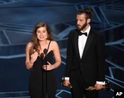 Rachel Shenton, left, and Chris Overton accept the award for best live action short for "The Silent Child" at the Oscars on Sunday, March 4, 2018, at the Dolby Theatre in Los Angeles. (Photo by Chris Pizzello/Invision/AP)