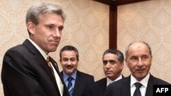 Ambassador Christopher Stevens, left, shook hands with Libyan National Transitional Council chairman Mustafa Abdel Jalil after a meeting in Tripoli on June 7