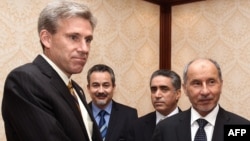 US ambassador to Libya, J. Christopher Stevens (L), shaking hands with Libyan National Transitional Council (NTC) chairman Mustafa Abdel Jalil (R) after presenting his credentials during a meeting in Tripoli, June 7, 2012.