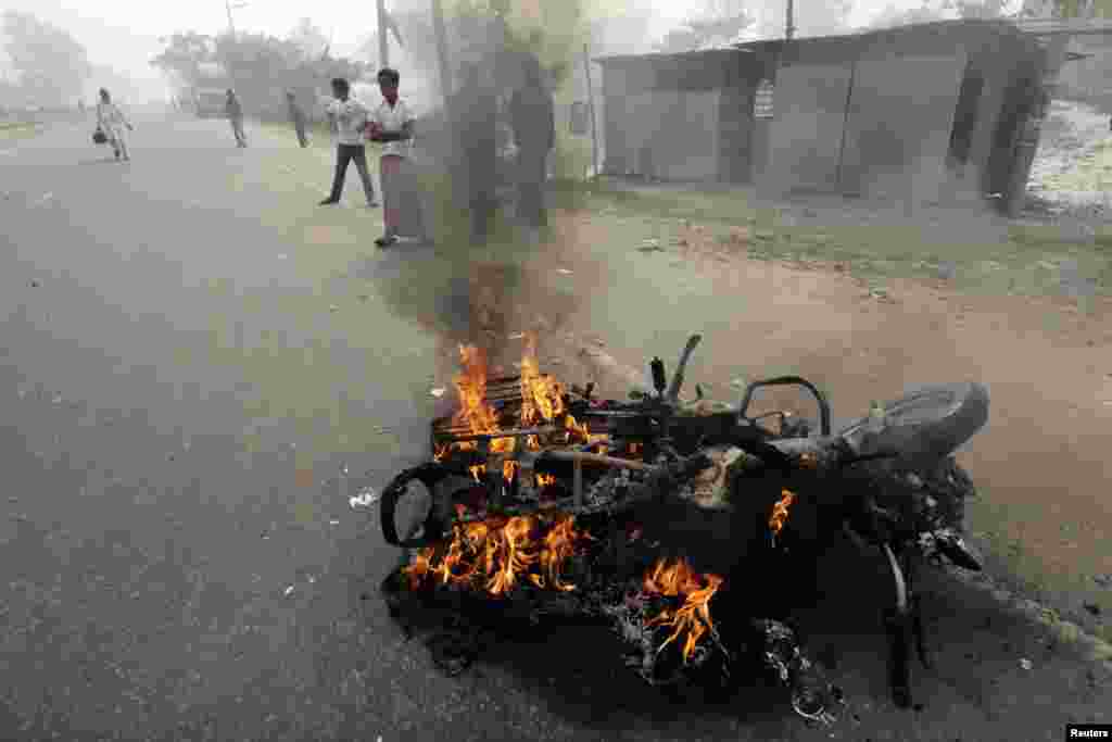 A motorcycle is seen on fire after activists of the Bangladesh Nationalist Party (BNP) set fire to it during a nationwide blockade in Kachpur near Dhaka December 9, 2012. Police fired rubber bullets and tear gas to disperse protesters staging blockades ac