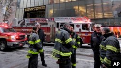 New York City Fire Deptartment vehicles sit on Fifth Avenue in front of Trump Tower, in New York, Monday, Jan. 8, 2018. The department says the fire started around 7 a.m. Monday in the heating and air conditioning system of the building on Fifth Avenue in Manhattan. (AP Photo/Richard Drew)