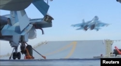 A still image taken from a video footage and released by Russia's Defense Ministry on Nov. 15, 2016, shows a jet taking off from Russian Admiral Kuznetsov aircraft carrier near the coast of Syria.
