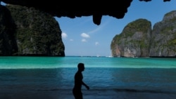 A tourist visits Maya Bay as Thailand reopens its world-famous beach after closing it for more than three years to allow its ecosystem to recover from the impact of overtourism, at Krabi province, Thailand, January 3, 2022. REUTERS/Jorge Silva