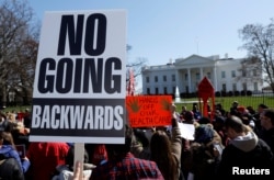 Protesters demonstrate against U.S. President Donald Trump and his plans to end Obamacare outside the White House in Washington, U.S., March 23, 2017.