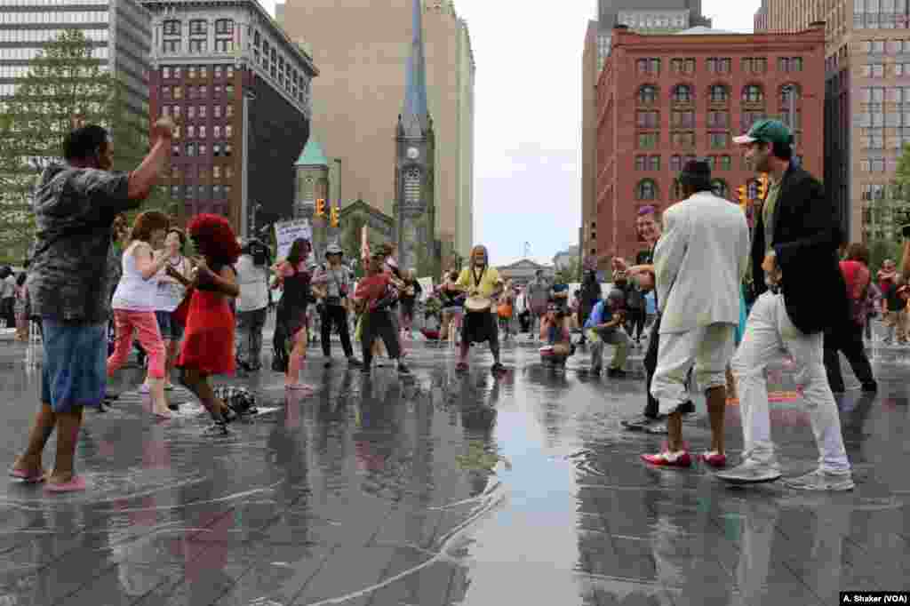 People gather to dance and enjoy the water sprinklers at Public Square during the Republican National Convention, in Cleveland, July 21, 2016.