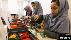 Members of an Afghan robotics team that was denied entry into the United States for a competition work on their robots in Herat province, Afghanistan, July 4, 2017. 