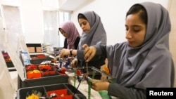 Members of Afghan robotics girls team, which was denied entry into the United States for a competition, work on their robots in Herat province, Afghanistan.