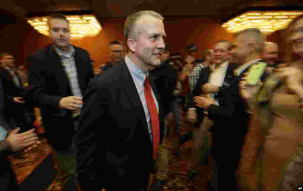 In Alaska, Republican U.S. Senate candidate Dan Sullivan walks to the stage to greet supporters on election night in Anchorage, Nov. 4, 2014. 
