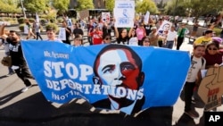 FILE - Upset with President Barack Obama's immigration policy, about 250 people march to the U.S. Immigrations and Customs Enforcement office with a goal of stopping future deportations in Phoenix, Arizona. 