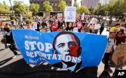 FILE - Upset with President Barack Obama's immigration policy, about 250 people march to the U.S. Immigrations and Customs Enforcement office with a goal of stopping future deportations in Phoenix, Arizona.