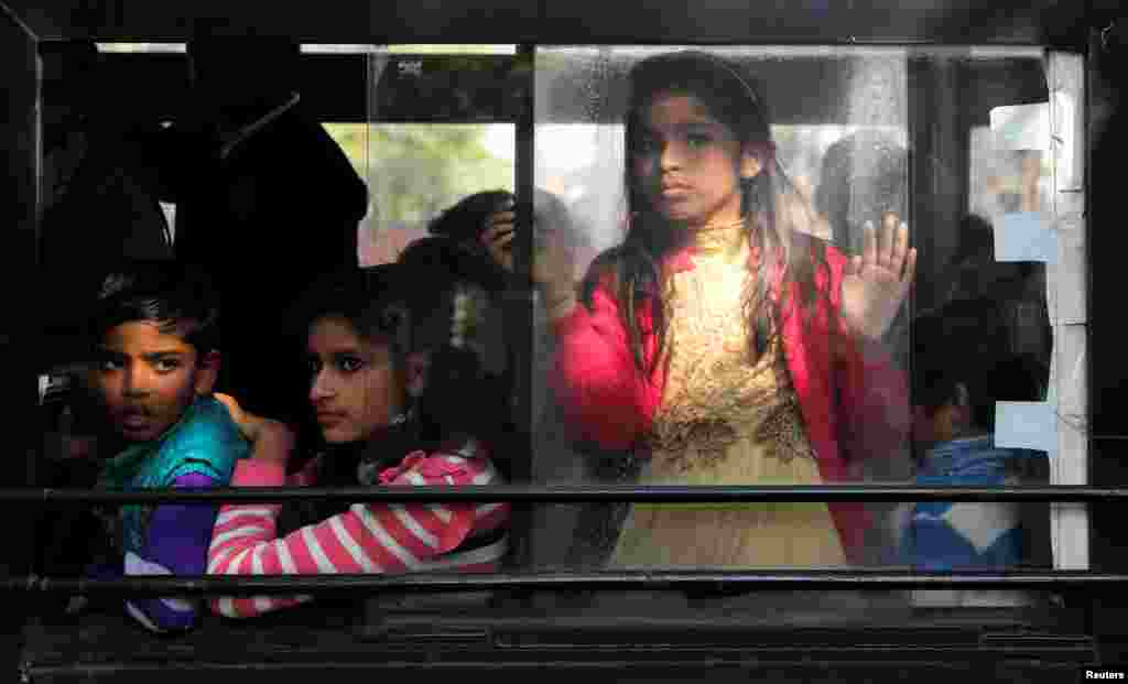 People observe a protest against a new citizenship law from a bus, in New Delhi, India.