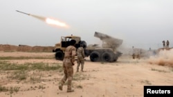 FILE - Iraqi soldiers fire a rocket toward Islamic State militants on the outskirt of the Makhmour south of Mosul, Iraq, March 25, 2016. 