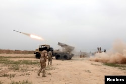 FILE - Iraqi soldiers fire a rocket toward Islamic State militants on the outskirt of the Makhmour south of Mosul, Iraq, March 25, 2016.