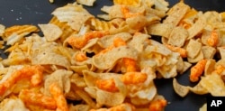 A mixture of salty snacks and chips is shown left on a table in Pittsburgh's Market Square on Tuesday, Feb. 7, 2012