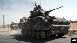 Turkish troops head to the Syrian border, in Karkamis, Turkey, Aug. 27, 2016. Turkey on Wednesday sent tanks across the border to help Syrian rebels retake the key Islamic State-held town of Jarablus and to contain the expansion of Syria's Kurds in an area bordering Turkey.