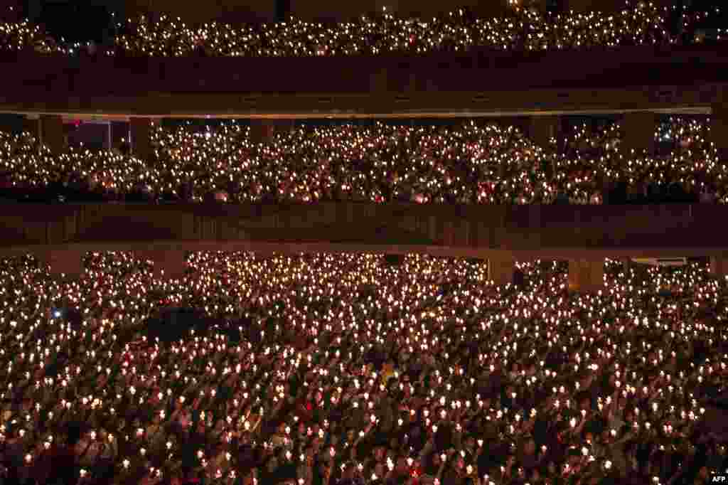 Christians hold candles during a Christmas Eve prayer at a church in Surabaya, East Java, Indonesia.