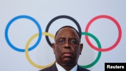 FILE - Senegal's President Macky Sall poses after signing the contract for the 2022 Youth Olympic Games, to be hosted in Senegal, at the 133rd IOC session in Buenos Aires, Argentina, Oct. 8, 2018.