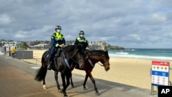 Mounted police patrol along Bondi Beach in Sydney, June 28, 2021.