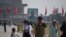 Visitors walk near a portrait of Sun Yat-sen, the first provisional president of the Republic of China, in Beijing's Tiananmen Square on Labour Day, May 1, 2020.