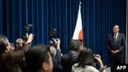 Japan's Prime Minister Shigeru Ishiba poses for photographs as he arrives for a press conference at the prime minister's office in Tokyo on Dec. 24, 2024.