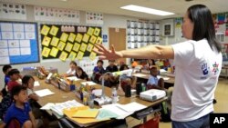 In this Sept. 30, 2016 photo, teacher Regina Yang leads a bilingual Korean-English language immersion classes at Porter Ranch Community School in Los Angeles. (AP Photo/Nick Ut)