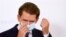 Austrian Chancellor Sebastian Kurz takes off a protective face mask as he arrives for a news conference amid a new coronavirus surge, in Vienna, Austria, Sept. 11, 2020. 